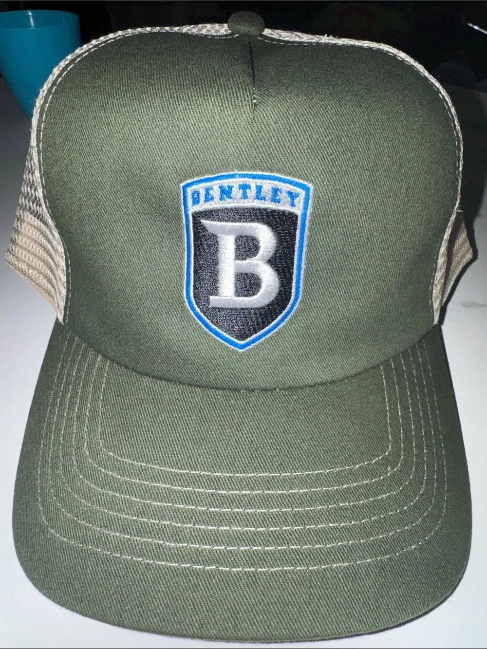 Olive green/khaki trucker hat with Bentley logo